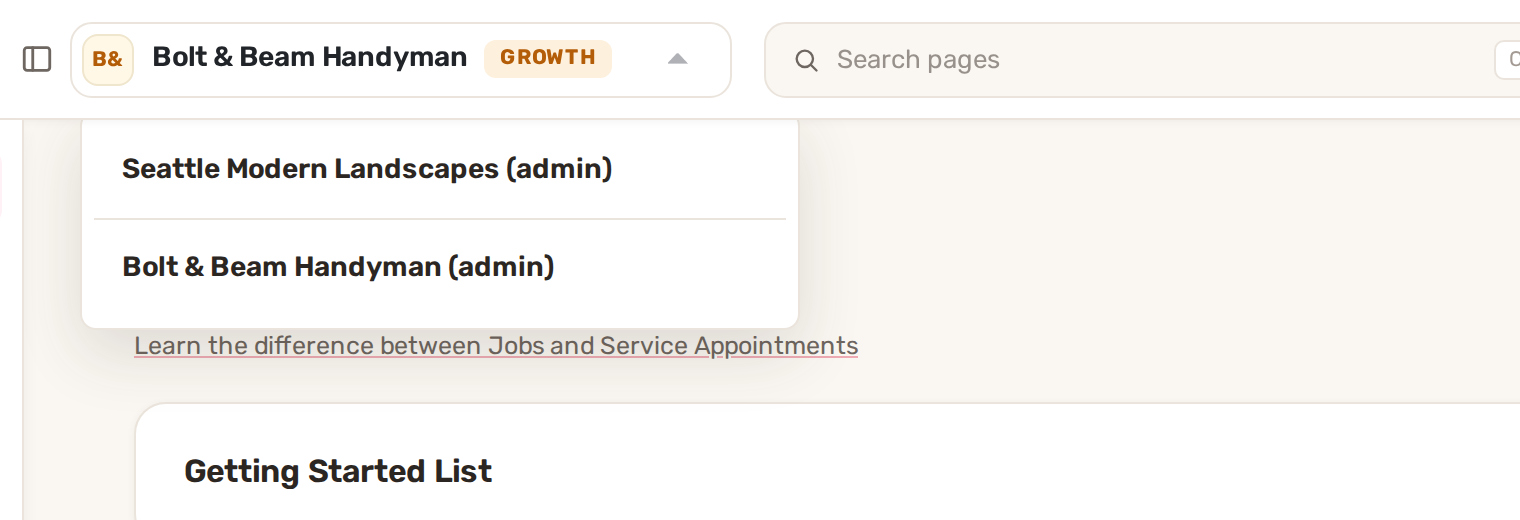 The business menu open at the top of the page, listing two businesses with the role in brackets